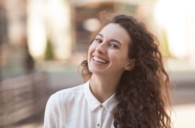 Happiness,Concept,-,Happy,Woman,Having,Fun,On,City,Street restorative dentist auburn