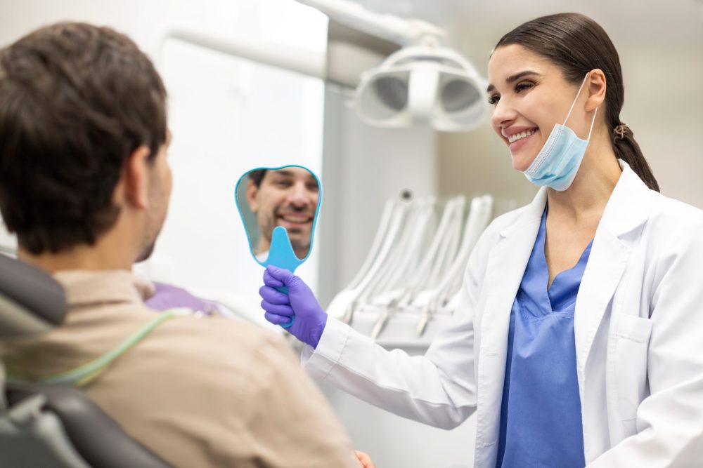 Positive,Man,Checking,Results,Of,Teeth,Whitening,Treatment,In,The dentist auburn
