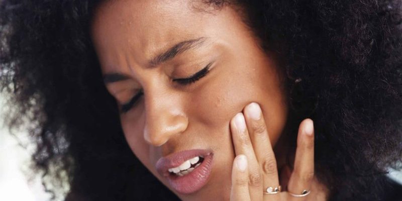 Toothache,,Sad,And,Face,Of,African,Woman,At,Home,For Emergency Dentist in Auburn