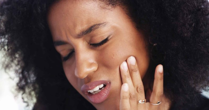 Toothache,,Sad,And,Face,Of,African,Woman,At,Home,For Emergency Dentist in Auburn
