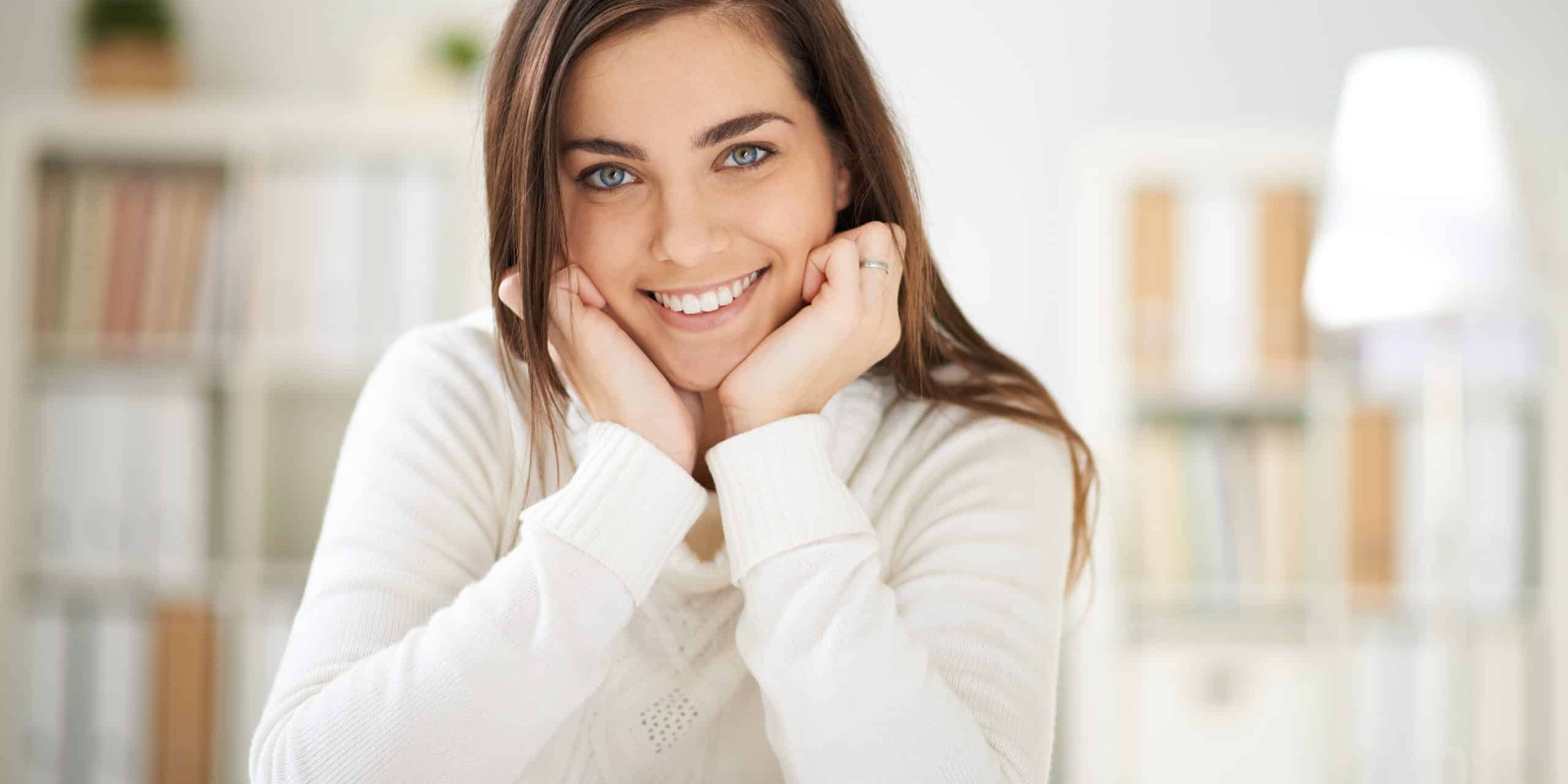 Happy,Girl,In,White,Pullover,Looking,At,Camera,With,Smile