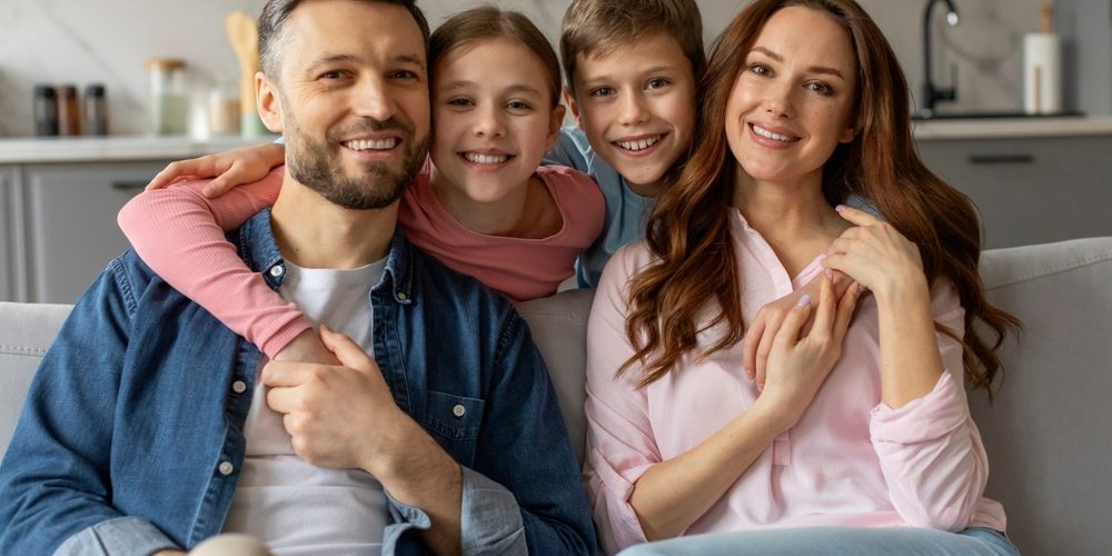 A,Contented,Family,Of,Four,Parents,,Daughter,And,Son,Poses Family Dentist Auburn