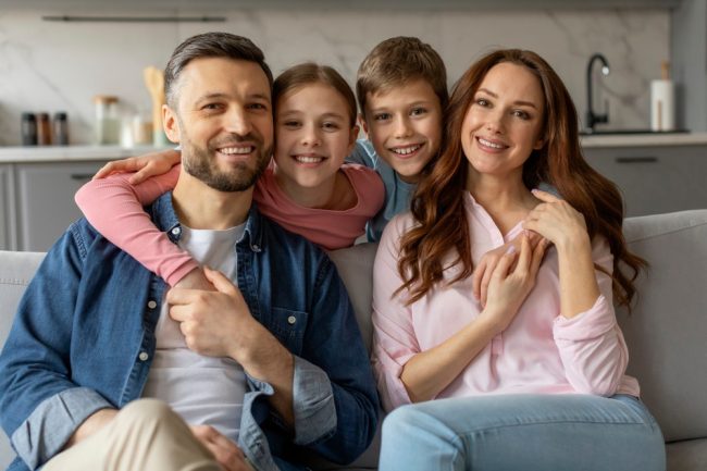 A,Contented,Family,Of,Four,Parents,,Daughter,And,Son,Poses Family Dentist Auburn
